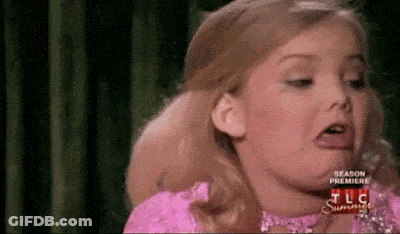 Little Girl In Pink Dress Making A Face GIF