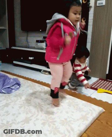 Little Girl In Pink Jacket Jumping GIF