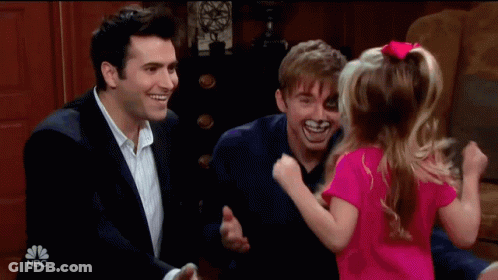 Little Girl In Pink Shirt Hugged By Two Men On NBC GIF