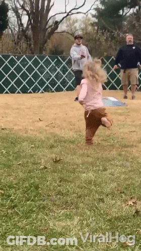 Little Girl In Pink Shirt Running In Grass GIF