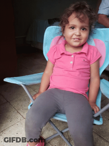 Little Girl In Pink Tommy Hilfiger Polo In Blue Chair GIF