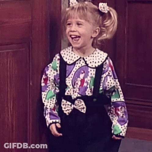 Little Girl In Polka Dot Shirt And Suspenders Smiling GIF