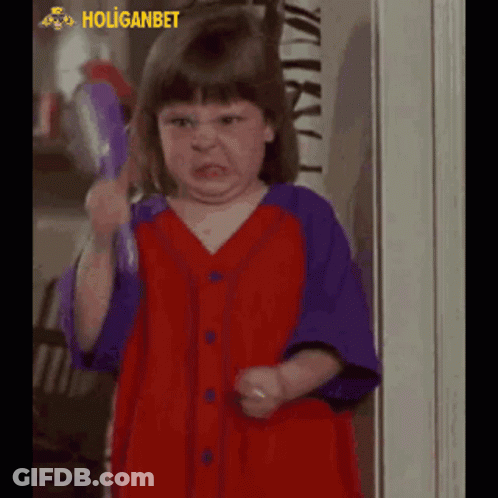 Little Girl In Red And Purple Shirt Making Funny Face GIF