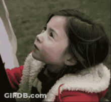 Little Girl In Red Jacket And White Fur Collar GIF