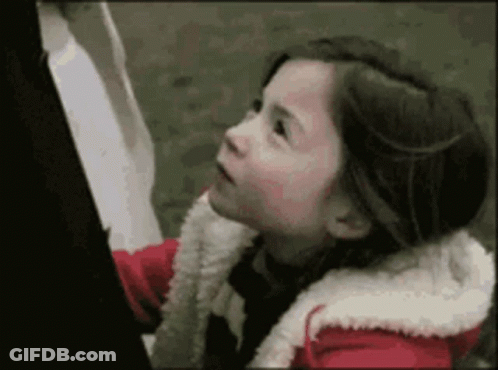 Little Girl In Red Jacket Looking Up GIF