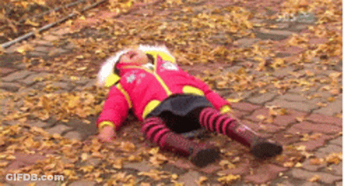 Little Girl In Red Jacket On Leafy Brick Sidewalk GIF
