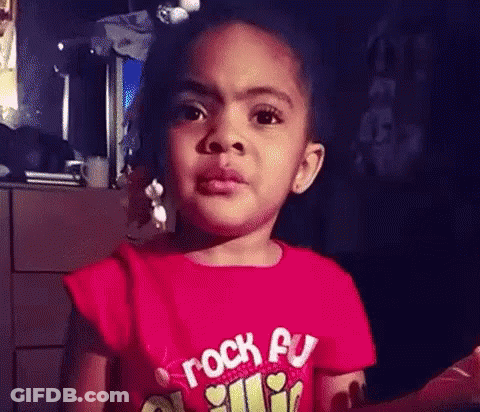 Little Girl In Red Rock On Shirt Making Funny Face GIF