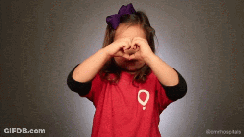 Little Girl In Red Shirt With O Making Heart Hands GIF