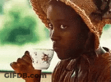 Little Girl In Straw Hat Drinking From White Cup GIF