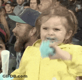 Little Girl In Yellow Jacket Eating Cotton Candy GIF