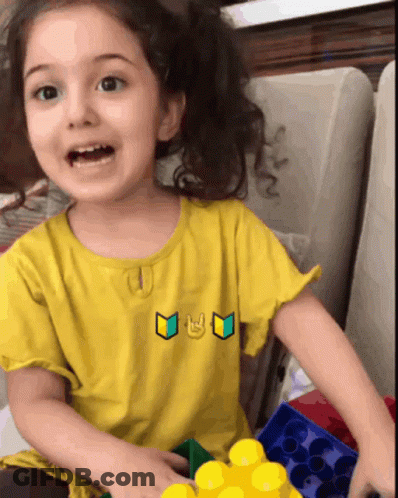 Little Girl In Yellow Shirt With Smiley Face GIF