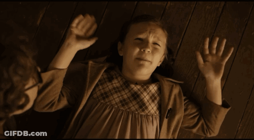 Little Girl Laying On Floor With Hands In Air GIF