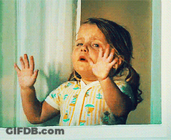 Little Girl Looking Out Window With Hands On Glass GIF