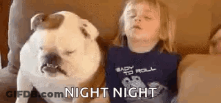 Little Girl Lying On Couch Next To Dog GIF
