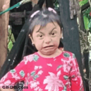 Little Girl Making Funny Face In Front Of Tree GIF