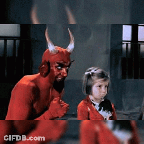 Little Girl Next To Man In Devil Costume GIF