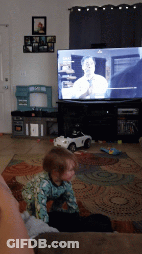 Little Girl On Couch Watching Fox News GIF