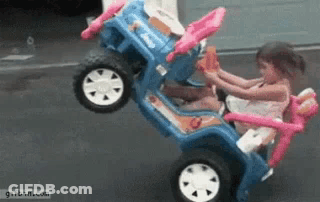 Little Girl Riding Blue Toy Jeep GIF