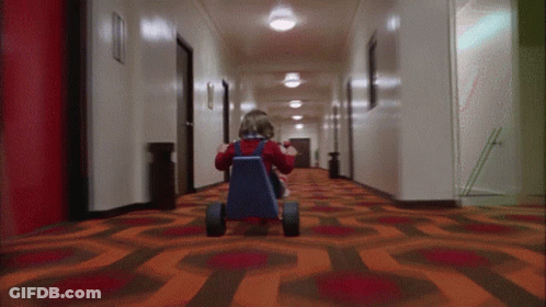Little Girl Riding Tricycle In Hallway GIF