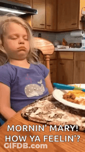 Little Girl Sitting At Table With Food GIF