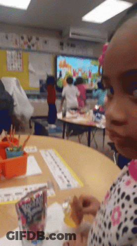 Little Girl Sitting At Table With Fruity Pebbles GIF
