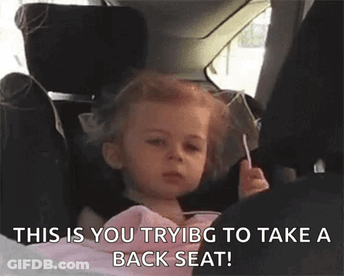 Little Girl Sitting In Car Seat Holding Lollipop GIF