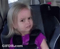 Little Girl Sitting In Car Seat With Purple Shirt GIF