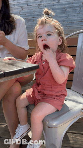 Little Girl Sitting On Chair Eating GIF