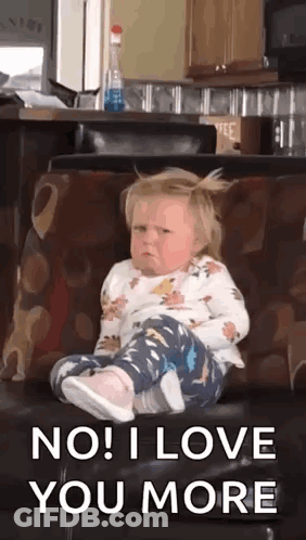 Little Girl Sitting On Couch With Legs Crossed Making Face GIF
