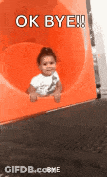 Little Girl Sitting On Orange Slide Saying Ok Bye GIF