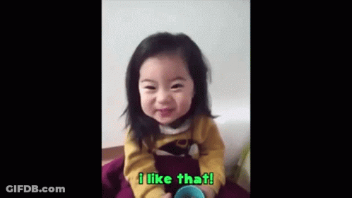 Little Girl Sitting Smiling With Cup GIF