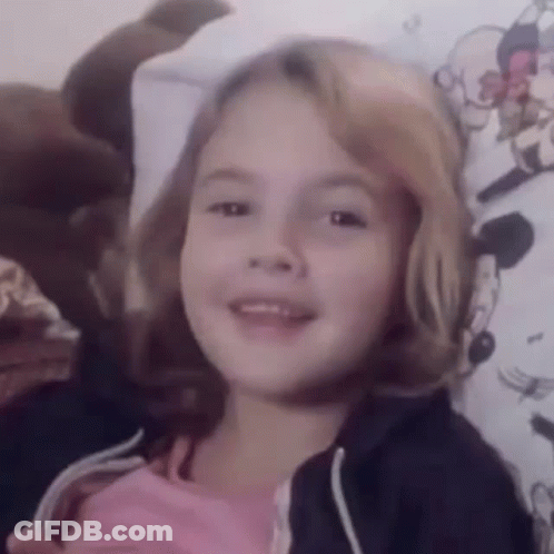 Little Girl Smiling On Bed GIF