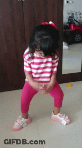Little Girl Squatting In Striped Shirt And Pink Pants GIF
