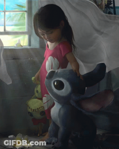 Little Girl Standing Next To Stitch Stuffed Animal GIF