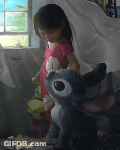 Little Girl Standing Next To Stuffed Animal GIF