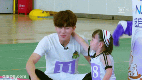 Little Girl Touching Man With Number 11 Shirt GIF