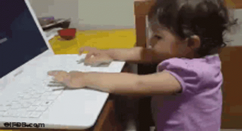 Little Girl Typing On Laptop GIF