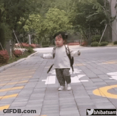 Little Girl Walking Down Brick Sidewalk With Backpack GIF