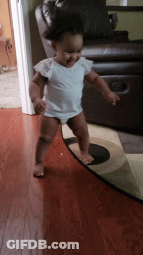 Little Girl Walking On Rug Smiling GIF