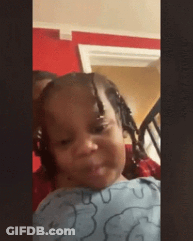 Little Girl With Braids Sitting In Chair Making Face GIF