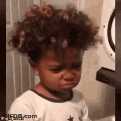 Little Girl With Curly Hair Crying In Front Of Washer And Dryer GIF
