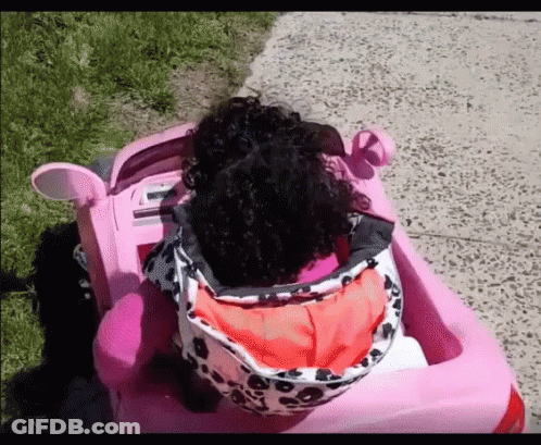 Little Girl With Curly Hair In Pink Car GIF