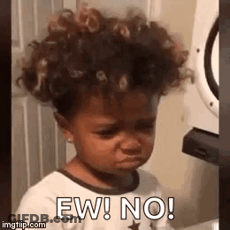 Little Girl With Curly Hair Making Funny Face By Washing Machine GIF