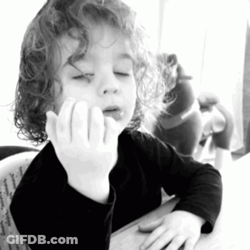 Little Girl With Curly Hair Sitting With Hand On Face GIF