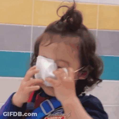 Little Girl With Face Mask At Tiled Wall GIF