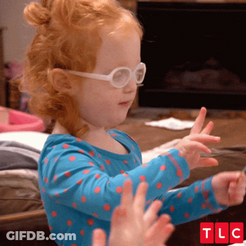 Little Girl With Glasses And Blue Polka Dot Shirt Clapping GIF