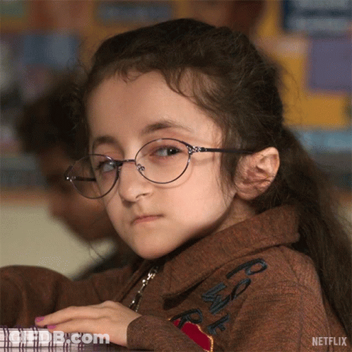 Little Girl With Glasses At Desk And Netflix Logo GIF