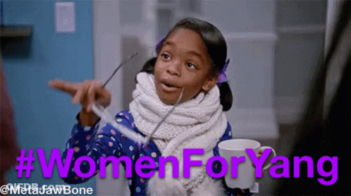 Little Girl With Scarf Holding Cup Pointing Women For Yang GIF