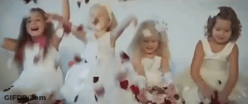 Little Girls In White Dresses Jumping With Feathers GIF