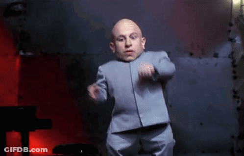 Little Man In Suit Dancing In Dark Room GIF